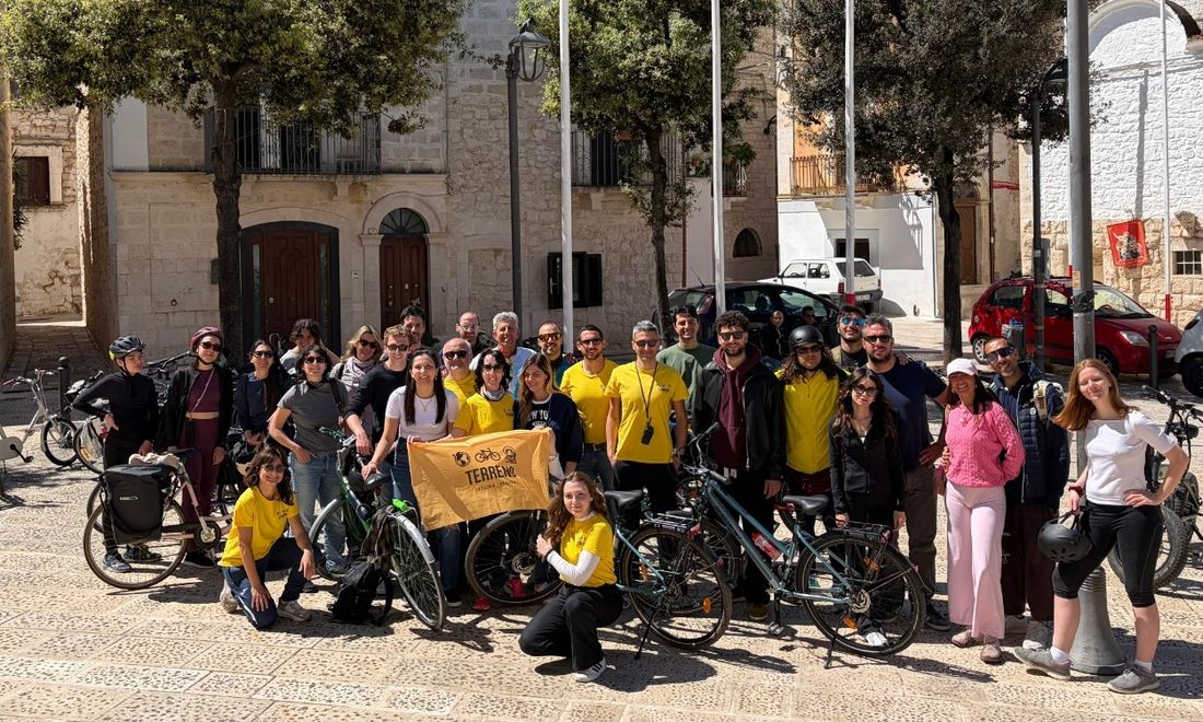 Group photo with the Terreno Cycling Therapy flag after a ride